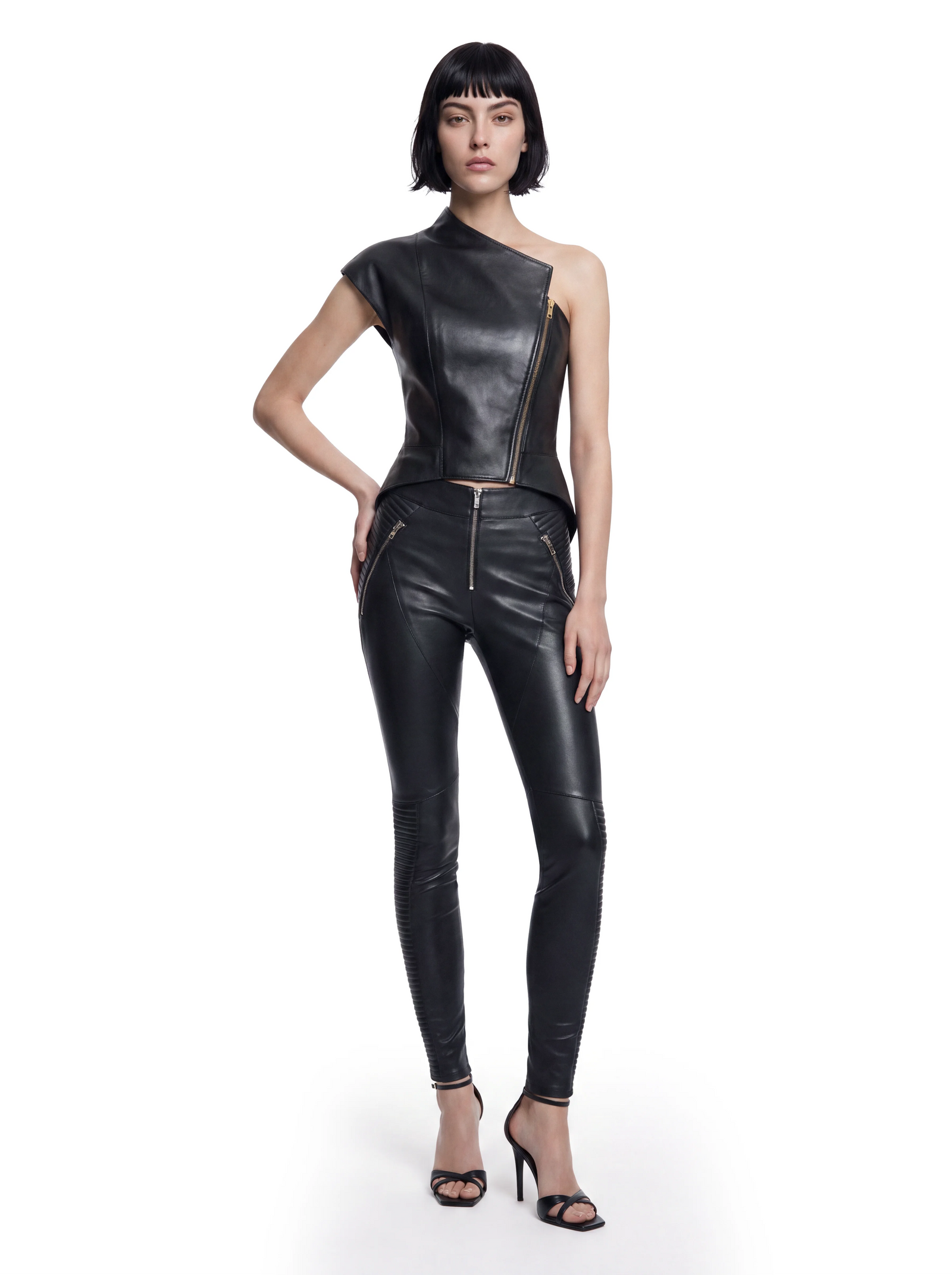 Luxus Designer Hose für Damen aus schwarzem Stretch-Lammleder mit körpernaher Passform, markanten Reißverschlusstaschen und dekorativen Steppdetails an den Beinen.